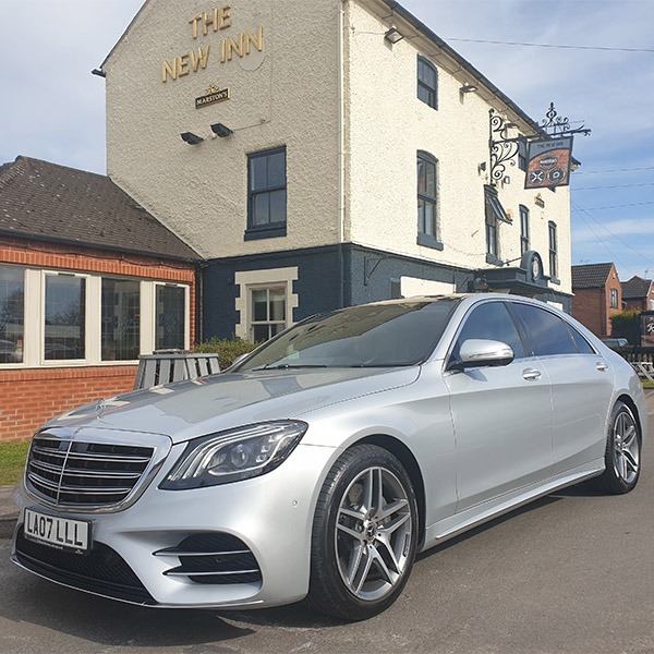 Mercedes S class in the sun outside of a pub