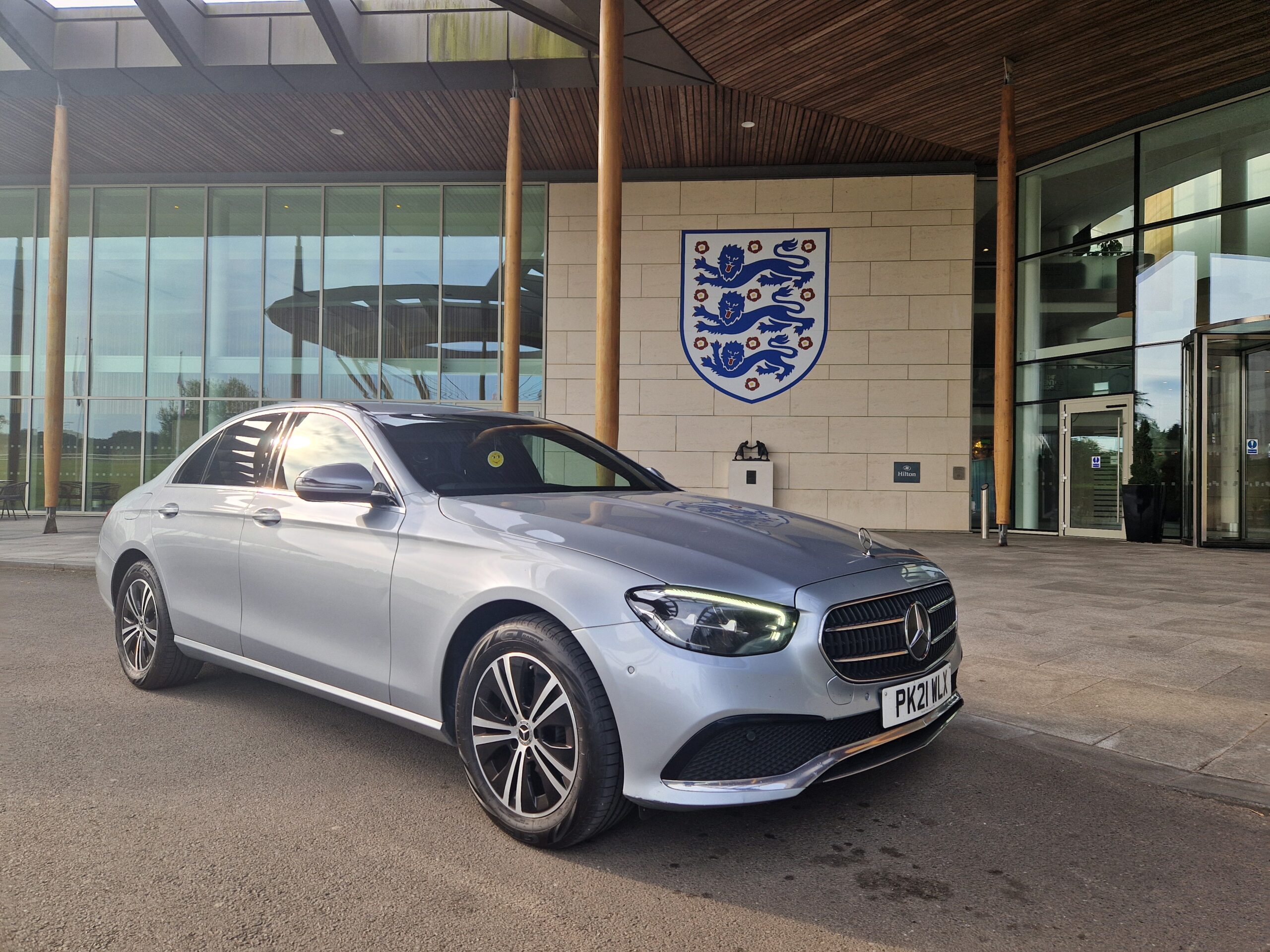 A silver Mercedes E-Class outside St George's Park, the England football training centre