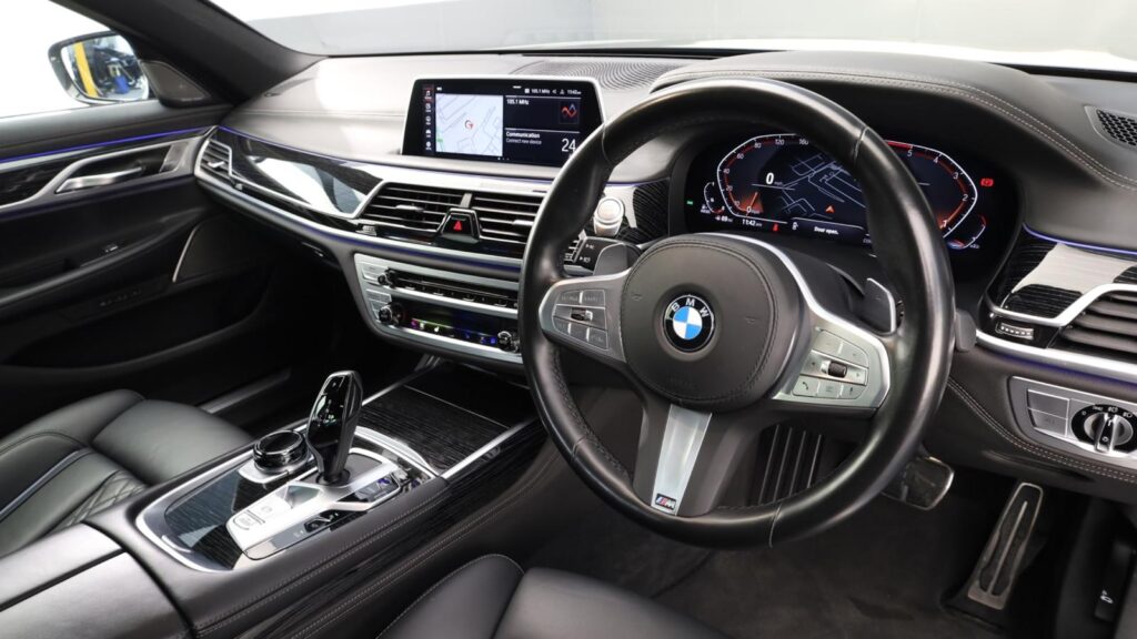 Interior of a BMW 7 Series chauffeur car, showing the dashboard and leather seats