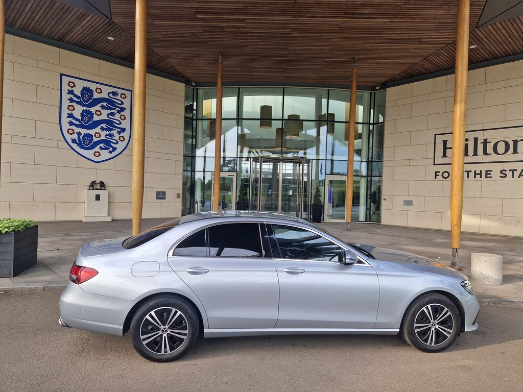 Silver Mercedes E-Class chauffeur car outside the Hilton at St George's Park