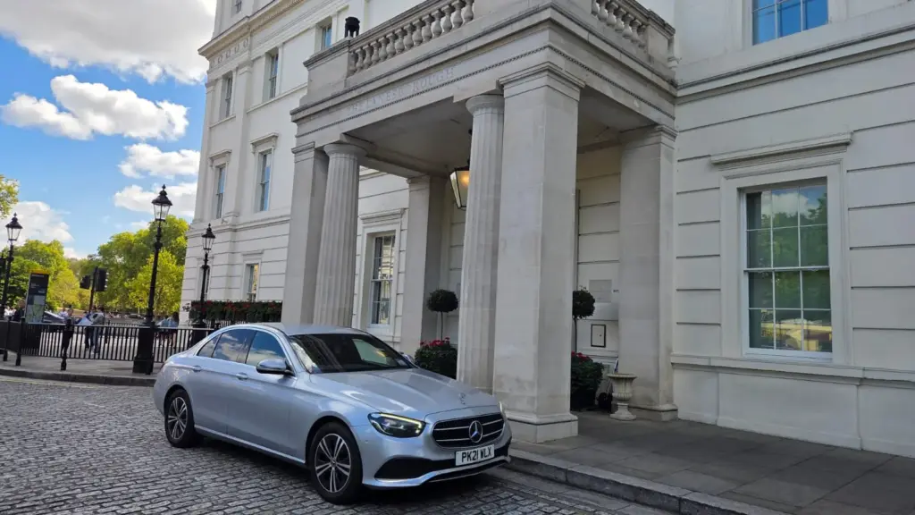 A silver Mercedes E-Class outside The Lanesborough, London