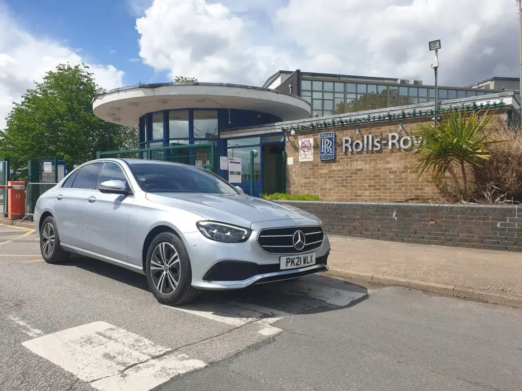 A silver Mercedes E-Class at a Derby works entrance