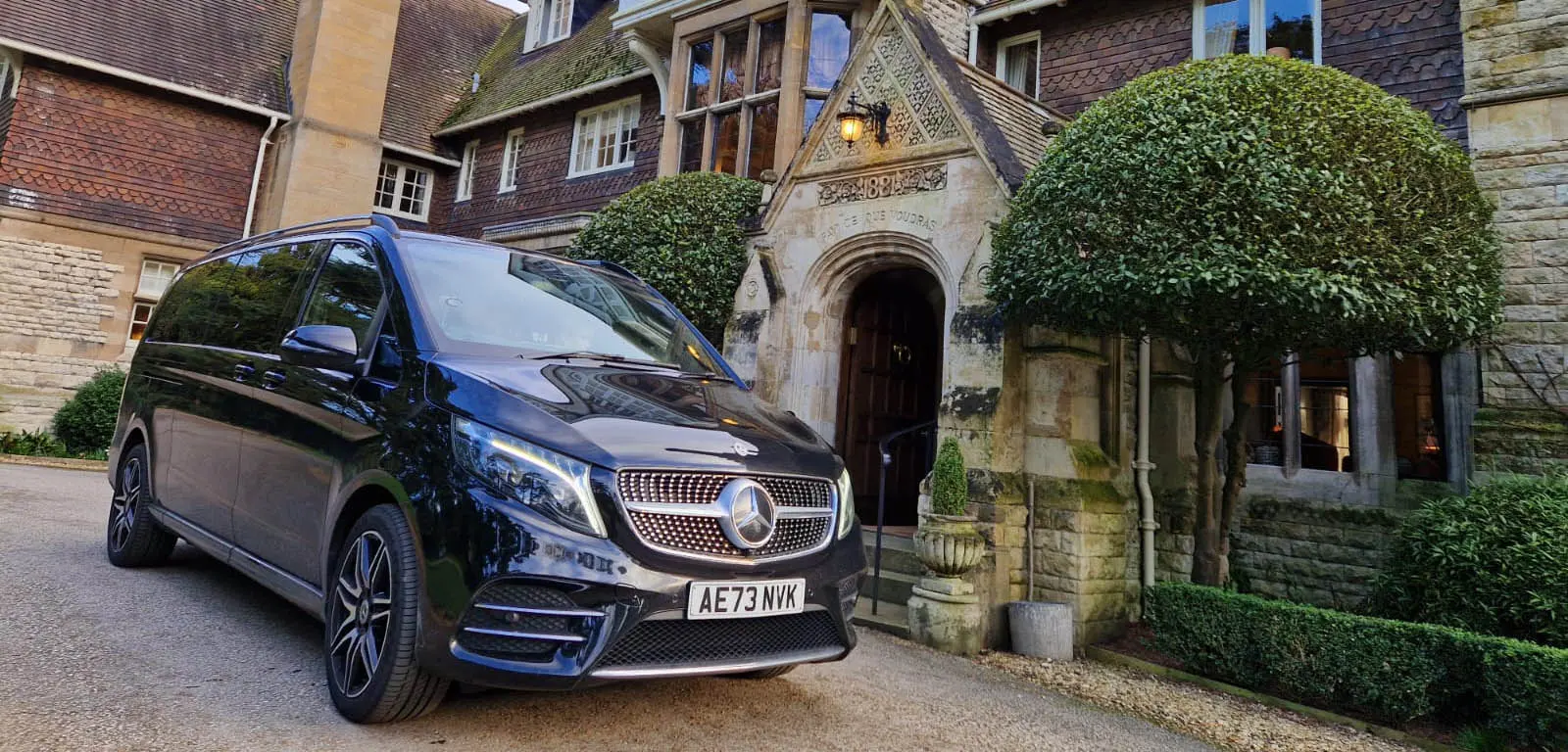A Mercedes V-Class waiting at the door of a country house near Derby